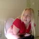 A plump. blonde, European girl takes a wet-sounding, loose shit while sitting on a toilet. She sprays deodorant into the air because of the smell. She wipes her ass when finished. Audio is somewhat compressed. Presented in 720P HD. Over 4 minutes.